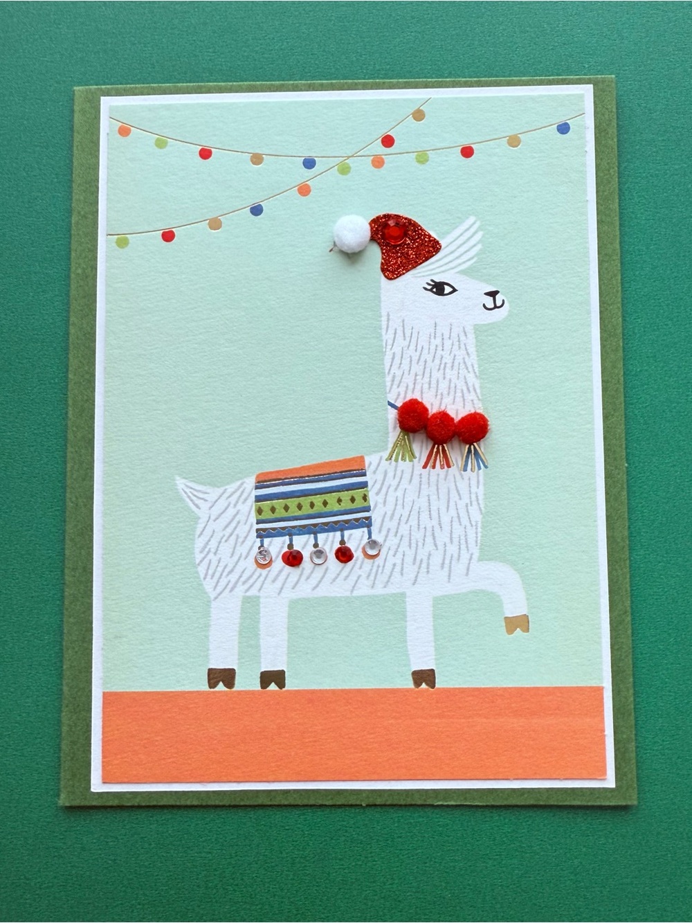Llama Holiday Card - featuring an adorned “ticas” necklace & “aretes” blanket.